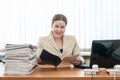 Welcoming receptionist a woman looking at camera with schedule or list Royalty Free Stock Photo