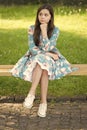 Welcoming relaxed atmosphere. Small girl beauty. Thoughtful look of small kid. Small child sit on park bench. Cute small Royalty Free Stock Photo