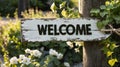 Shabby White Wooden Post with Welcome Sign at the Entrance of a Garden Royalty Free Stock Photo