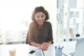 Welcoming you to another year of success and prosperity. Portrait of a confident young businesswoman sitting at her desk Royalty Free Stock Photo