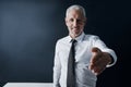 Welcoming you to the company. Cropped portrait of a mature businessman offering you his hand of agreement. Royalty Free Stock Photo