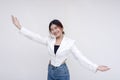 A welcoming young woman holding her arms wide open in greeting while looking at the camera. Isolated on a white background Royalty Free Stock Photo