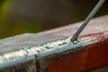 Weld on a metal profile and a welding electrode