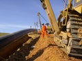 Welded Gas Pipeline Being Buried Into Trench