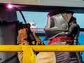 A welder welds a wharf headstock to a pile