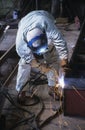Welder bending down welding at Work
