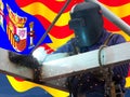 Welder of Catalunya with Spain with his flag in the background Royalty Free Stock Photo