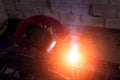 Welder cooks metal and sparks fly close up