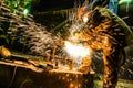 Welder cooks a steel structure. Sparks are flying. The work of a