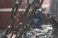 Welder doing welding on deck of ship lashing cargo