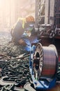 Welder doing welding on deck of ship lashing cargo