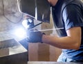 Welder doing welding in a metal workshop