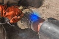 A welder is engaged in welding work on the polyethylene pipe of the heating main pipeline at the construction site