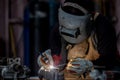 Welder in face mask welds with argon arc stainless steel welding, Industrial worker at the factory welding steel structure, Welder Royalty Free Stock Photo