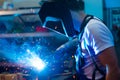 Welder in factory on the machine