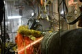 A welder is grinding weld joint on offshore pipeline