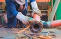 Welder hand using electric grinder machine to polishing steel pipe for improving oil pipeline system work in tanker ship