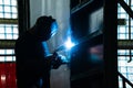 Welder in his workshop welding metal, lots of sparks flying around Royalty Free Stock Photo