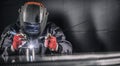 Welder industrial worker welding with argon machine