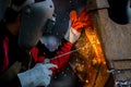 Welder in iron mask helmet welds with electric arc steel welding, Industrial worker at the factory welding steel structure, Welder Royalty Free Stock Photo