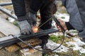 Welder man welding metal iron with electrodes, worker wearing protective helmet and gloves. Close up of electrode welding and Royalty Free Stock Photo