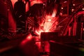 Welder in mask welding metal authentic shooting through red safe Royalty Free Stock Photo