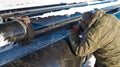 Welder performs welding pipeline in winter conditions Royalty Free Stock Photo