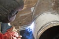 Welder performs welding works on pipelines