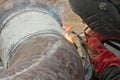 Welder performs welding works on pipelines stainless steel