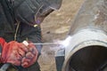 Welder performs welding works on pipelines stainless steel