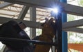 Welder in position over head action. Royalty Free Stock Photo