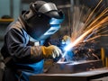 welder with protective mask and welding sparks in the factory