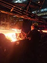 Welder in protective uniforms and masks at the pipe mill. metallurgy industry