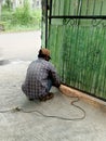 The welder is repairing the broken door of the house Royalty Free Stock Photo
