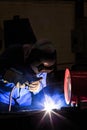 Welder repairing surface by shield metal arc welding Royalty Free Stock Photo