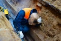 Welder repairs the pipeline in the mine