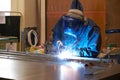 Welder in safety mask at work