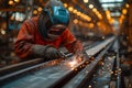 Welder in safety suit welding steel in a large factory Royalty Free Stock Photo