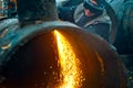 The welder sits near the pipe and cuts it with the help of cetylene welding.