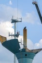 Welder takes a break from torching sections of the water tower while sitting on the large steel tube