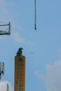 Welder takes a break from torching sections of the water tower while sitting on the large steel tube