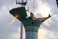 Welder taking a break from taking apart an old water tower