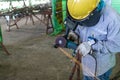 Welder is used Grinding machine to grinding remove tack weld on steel pipe before welding at Industrial factory Royalty Free Stock Photo