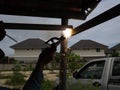 The welder using electrode welding the steel frame, Welding sparks light and smoke