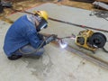 The welder is welding add joint a steel plate with process Flux Cored Arc Welding & x28;FCAW& x29; Royalty Free Stock Photo