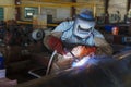 Welder is welding added joint a pipe carbon for steel structure work with process Flux Cored Arc Welding(FCAW) Royalty Free Stock Photo