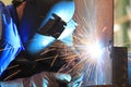 Welder is welding chekered plate with all safety