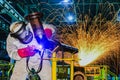 Welder is welding steel pipe in factory with spark light