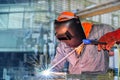 Welder is welding in factory with spark light. Royalty Free Stock Photo