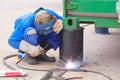 Welder Welding Metal bollards to use for support Foundation of the old Steel Container that have been renovated to outdoor Office